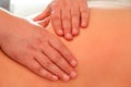 Close up detail of hands massaging female shoulder and back Royalty Free Stock Photo