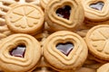 Close-up detail of heart-shaped cookies and strawberry jam, on a basket, for Valentine`s Day Royalty Free Stock Photo