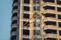 Close-up detail of highrise tower crane attached to building brick wall at hightower industrial construction site. Engineering and Royalty Free Stock Photo