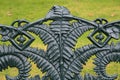 Close up detail of an intricately designed wrought iron garden bench