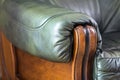 Close-up detail of leather sofa with oak wooden handle Royalty Free Stock Photo