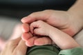 Close-up detail macro view of parent holding baby little hand in his big hand Royalty Free Stock Photo