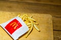 Close up detail of McDonalds french fries on a wooden table in Bucharest, Romania, 2020