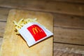 Close up detail of McDonalds french fries on a wooden table in Bucharest, Romania, 2020