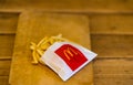 Close up detail of McDonalds french fries on a wooden table in Bucharest, Romania, 2020