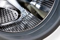 Close up detail of modern dirty or clean washing machine interior with open door interior. Silver shiny stainless drum Royalty Free Stock Photo