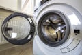 Close-up detail of modern washing machine interior with open door interior. Silver shiny stainless drum, design and technology