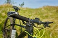 Close-up of detail of the mountain bicycle on the green grass.