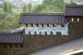 Close-up detail of new built brick plastered chimneys on house top with metal tile roof. Roofing, repair and renovation work Royalty Free Stock Photo