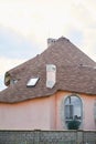 Close-up detail of new modern ecological cottage house top with shingled brown roof on blue sky background. Royalty Free Stock Photo