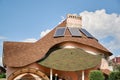 Close-up detail of new modern ecological cottage house top with shingled brown roof on blue sky background Royalty Free Stock Photo