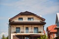 Close-up detail of new modern ecological cottage house top with shingled brown roof on blue sky background Royalty Free Stock Photo