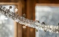 Close-up detail new year Christmas decoration, silver stars and rain on window light blurred bokeh background. Sparkling DIY Royalty Free Stock Photo