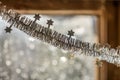 Close-up detail new year Christmas decoration, silver stars and rain on window light blurred bokeh background. Sparkling DIY Royalty Free Stock Photo