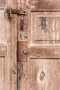 Close-up detail of old door panel closed with old door lock.