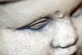 Close up detail of an old stone statue face Royalty Free Stock Photo