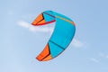 Close-up detail one bright blue orange kitesurf wings kite equipment fly against clear sky t on bright sunny day against Royalty Free Stock Photo