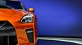 Detail of the one LED headlights orange sport car on blue background Royalty Free Stock Photo