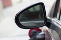 Close-up detail part of dirty back side view car mirror with blurred reflection on white copy space background. Transportation, sa Royalty Free Stock Photo