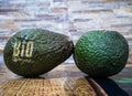 Close up detail photo with two avocado fresh organic bio fruit on the kitchen table