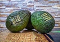 Close up detail photo with two avocado fresh organic bio fruit on the kitchen table