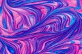 An abstract textured background of pink and blue metallic glitter paint swirls Royalty Free Stock Photo