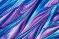 An abstract textured background of pink and blue metallic glitter paint swirls Royalty Free Stock Photo