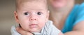 Close-up detail portrait of cute little peaceful newborn baby boy child face with beautiful open eyes Royalty Free Stock Photo