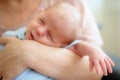 Close-up detail portrait of mother holding cute little peaceful newborn baby chield in her hands Royalty Free Stock Photo