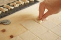 Close up detail of process of homemade vegan farfalle pasta with durum wheat flour. The cook kneads the dough on the wooden Royalty Free Stock Photo