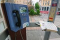 Close up detail of public telephone booth with telephone and open phone book inside. Royalty Free Stock Photo