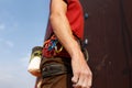 Close-up detail of rock climber wearing safety harness and climbing equipment outdoor wich chalk magnesium bag and Royalty Free Stock Photo