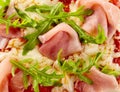 Close up detail of a rocket and ham Italian pizza