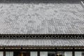 Close up detail roof tiles of Edo period architecture style with leaves less tree in Noboribetsu Date JIdaimura Historic Village.