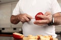Close-up detail of Caucasian man`s hands cutting apples in the kitchen Royalty Free Stock Photo