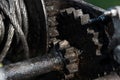 Close-up and detail shot of a greased winch. You can see the gears, the pulley and the steel cable Royalty Free Stock Photo