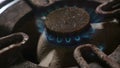 Close up detail shot of old rusty kitchen stove ring burning after switched on fire with lighter flame in dangerous gas energy and Royalty Free Stock Photo