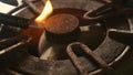 Close up detail shot of old rusty kitchen stove ring switched on fire with lighter flame burning in dangerous gas energy and Royalty Free Stock Photo