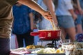 Close up detail shot of person's arm stirring a traditional tasty delicious pot of hot melted liquid swiss cheese fondue