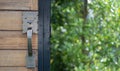 Close up detail shot of a wooden door with ornate handle with nature background Royalty Free Stock Photo