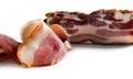 Close-up detail of a slice of bacon and a piece of bacon