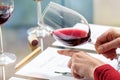 Wine steward evaluating red wine density Royalty Free Stock Photo