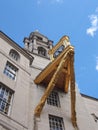 A close up detail of the tower and large ornate gold clock on leeds civic hall in west yorkshire against a sunlit cloudy sky Royalty Free Stock Photo