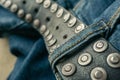 close up detail of an unbuckled leather belt on a faded pair of blue jeans Royalty Free Stock Photo