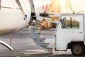 Close-up detail view of belt loading machine car load commercial parcel shipment in small cargo plane compartment. Air Royalty Free Stock Photo