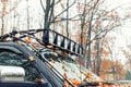 Close-up detail view of custom made roof rack bar with extra headlight mounted on roof of heavy duty pick up suv car Royalty Free Stock Photo