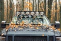 Close-up detail view of custom made roof rack bar with extra headlight mounted on roof of heavy duty pick up suv car Royalty Free Stock Photo