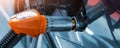Close-up detail view of fuel autogas pump gun connected with noozle adapter to car tank to refill at car gas filling Royalty Free Stock Photo