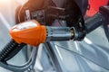 Close-up detail view of fuel autogas pump gun connected with noozle adapter to car tank to refill at car gas filling Royalty Free Stock Photo