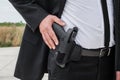 Close-up detail view of hand with gun in bandolier belt